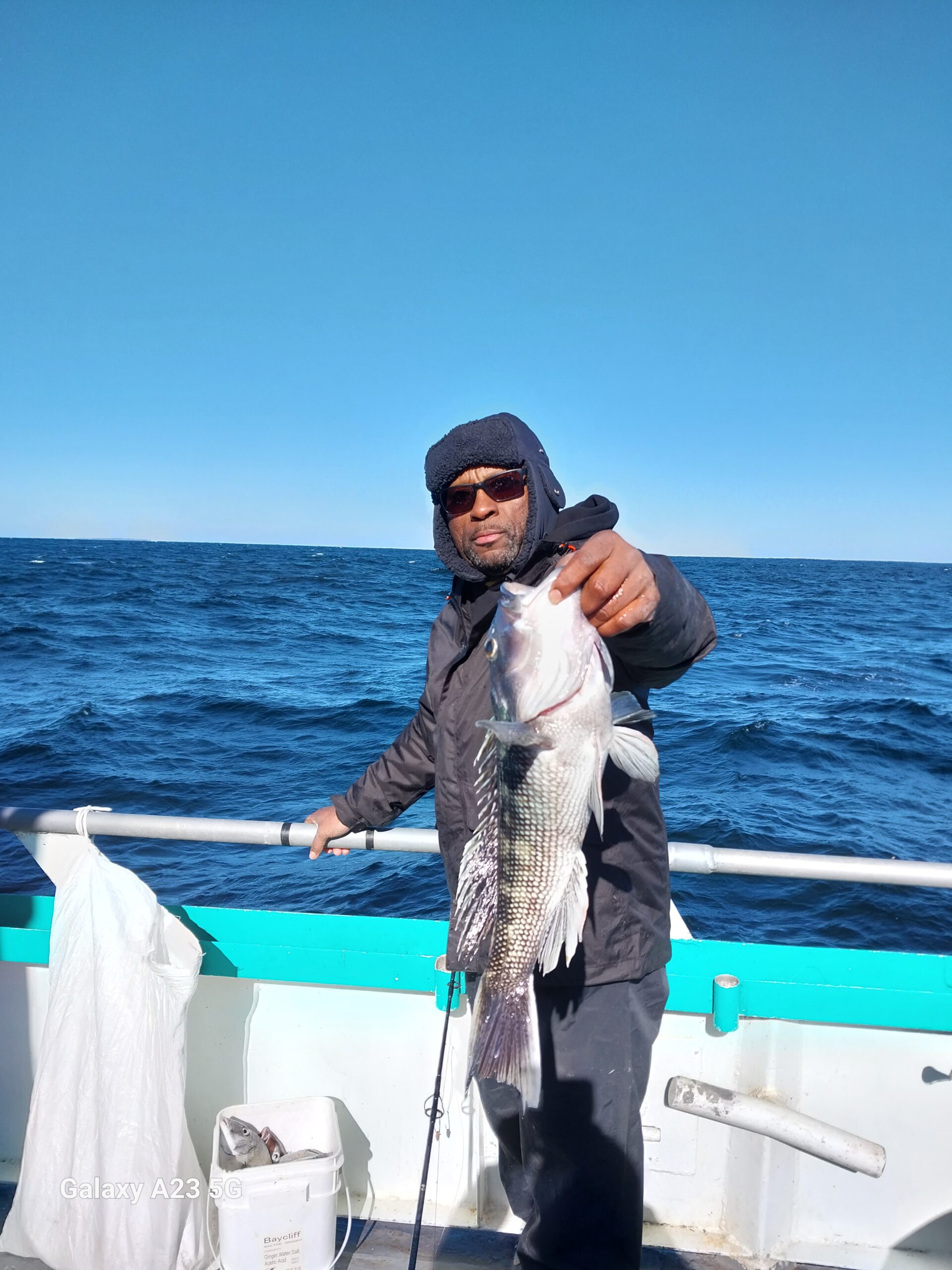 a man standing on a boat in the water