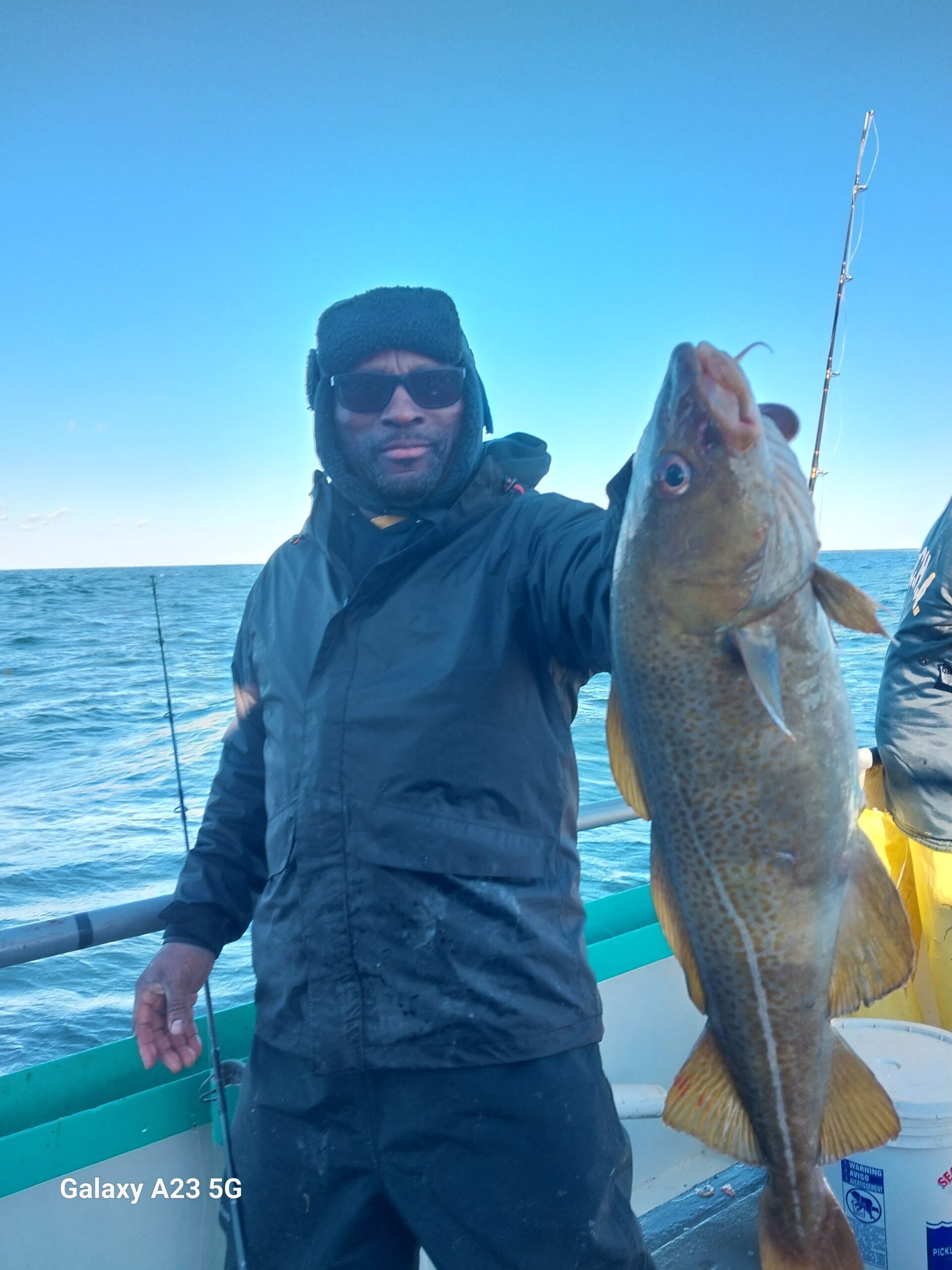 a man holding a fish in the water
