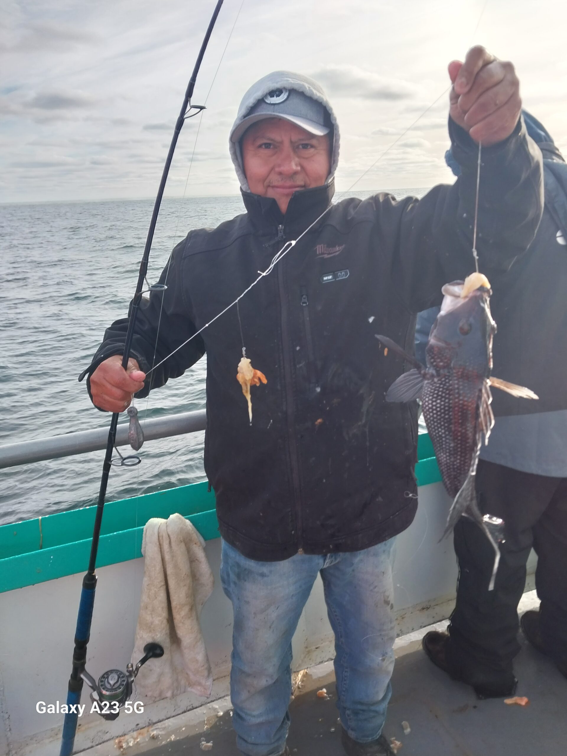 a person holding a fish in the water