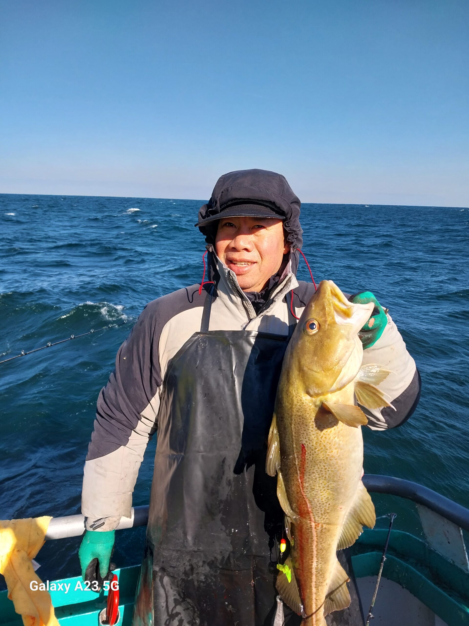a person holding a fish in the water