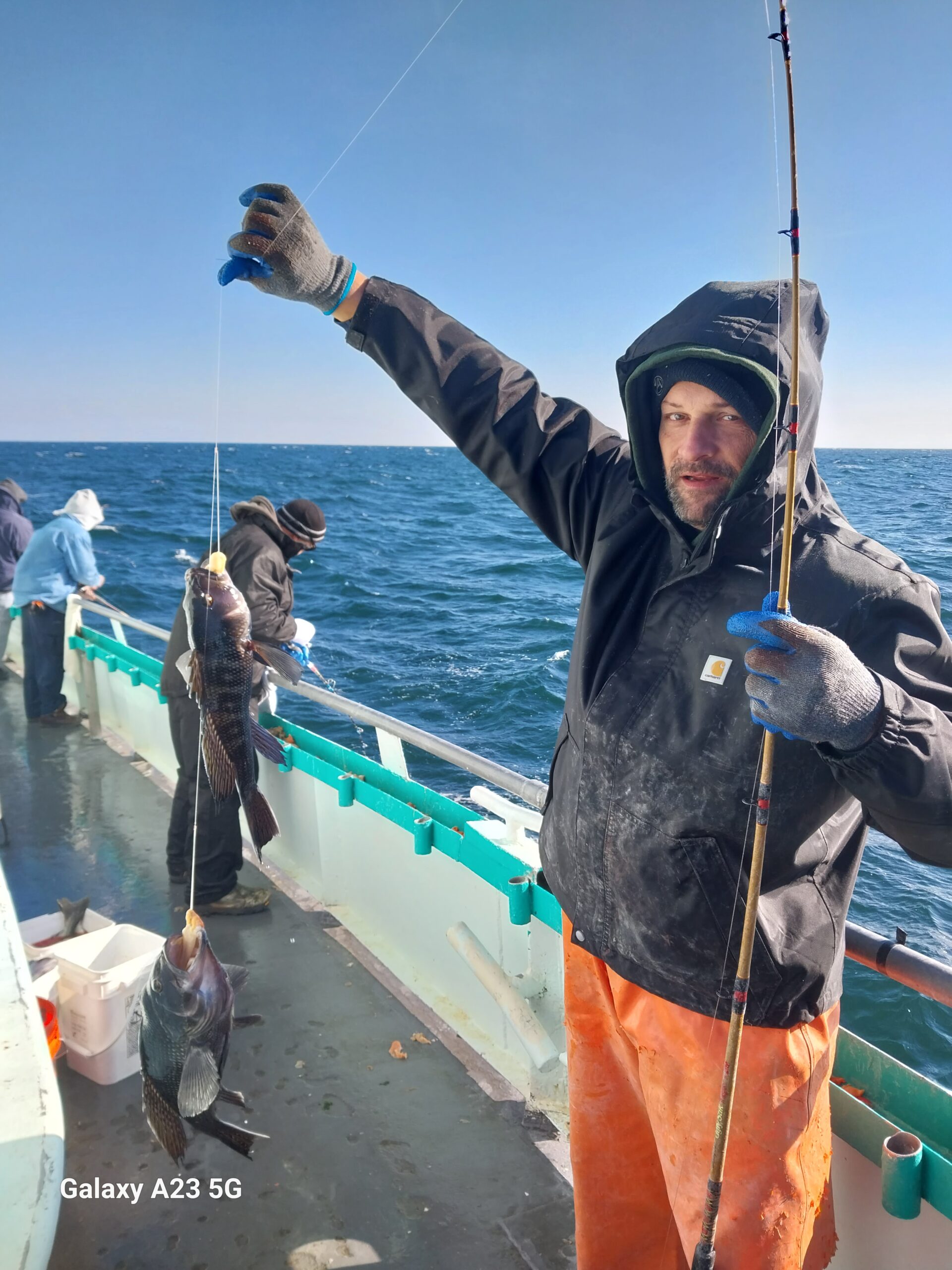 a person holding a fish in the water