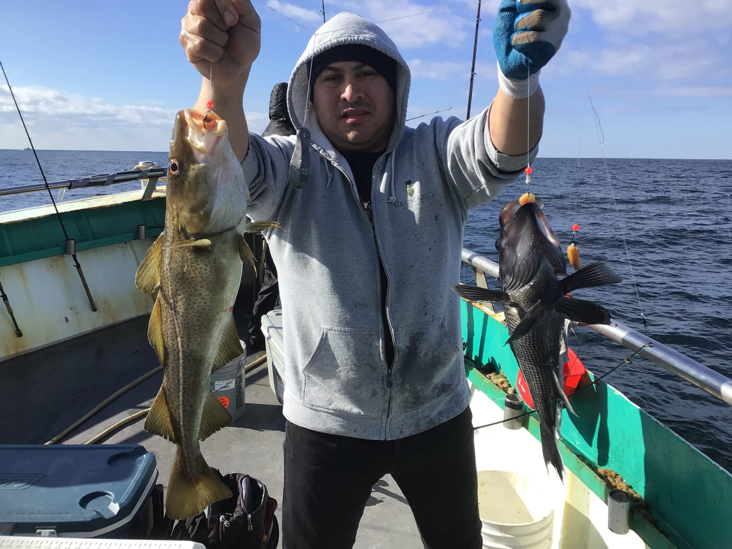 a person holding a fish on a boat