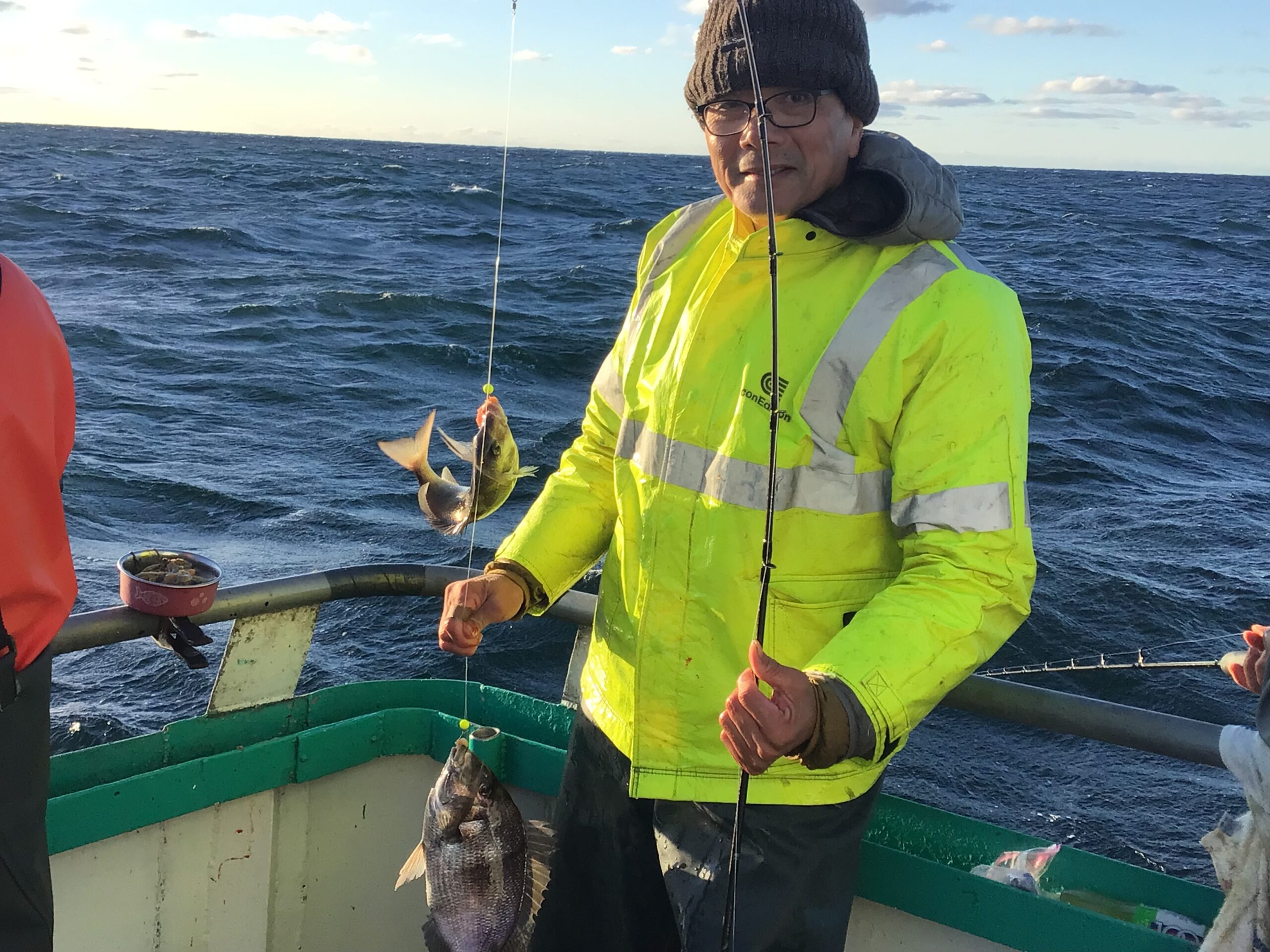 a man standing next to a body of water
