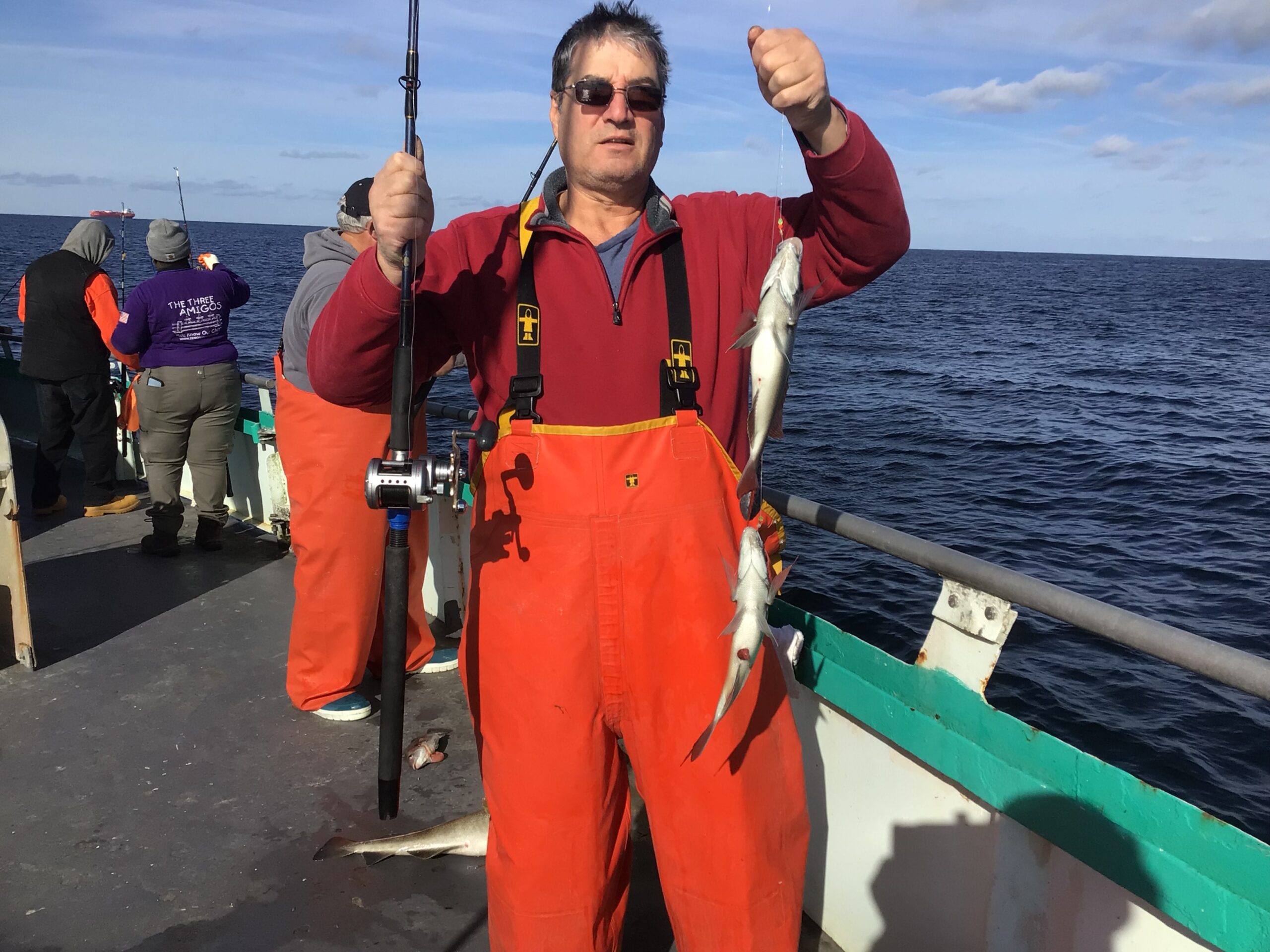a man standing next to a body of water