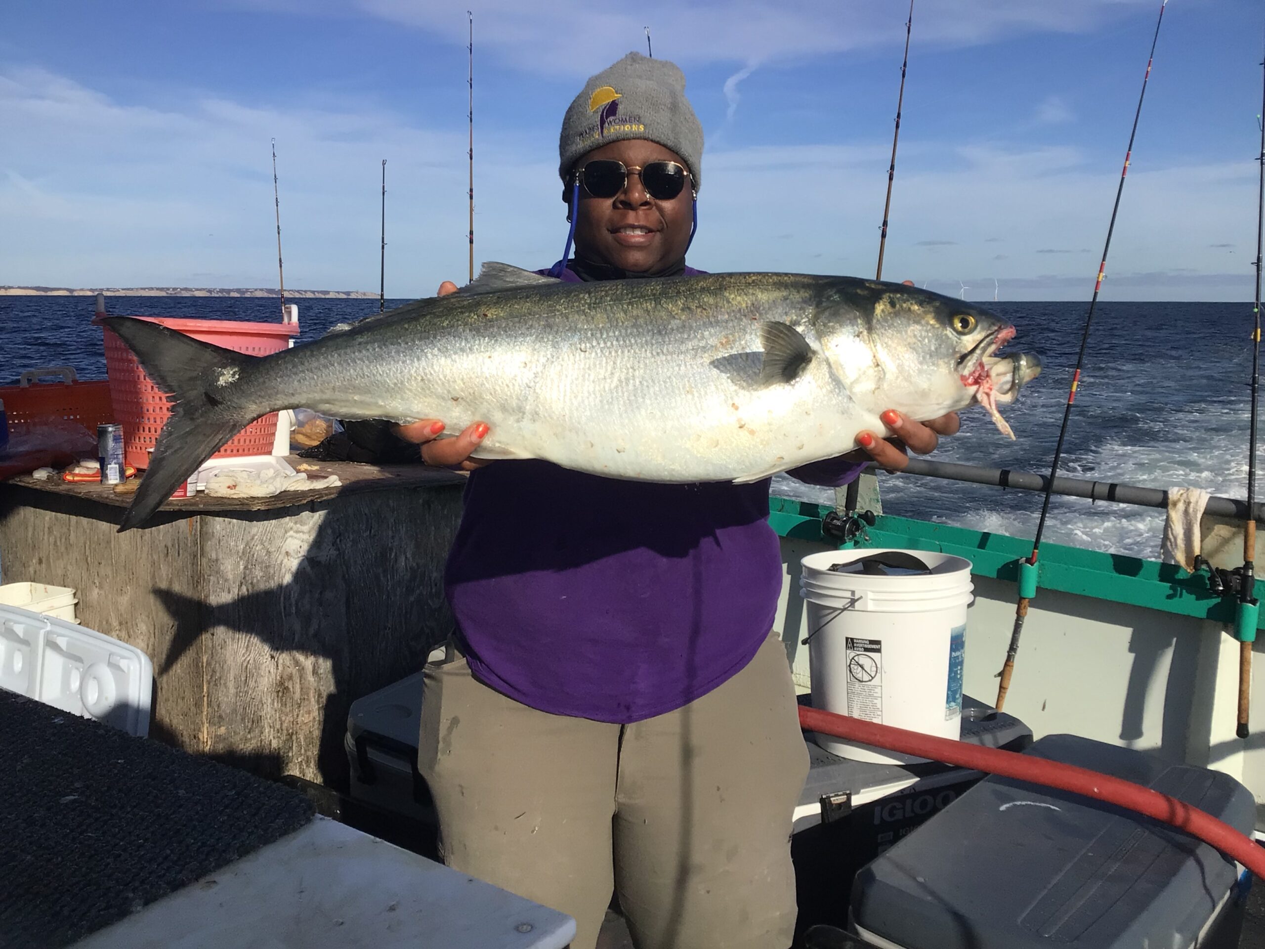 a person holding a fish on a boat