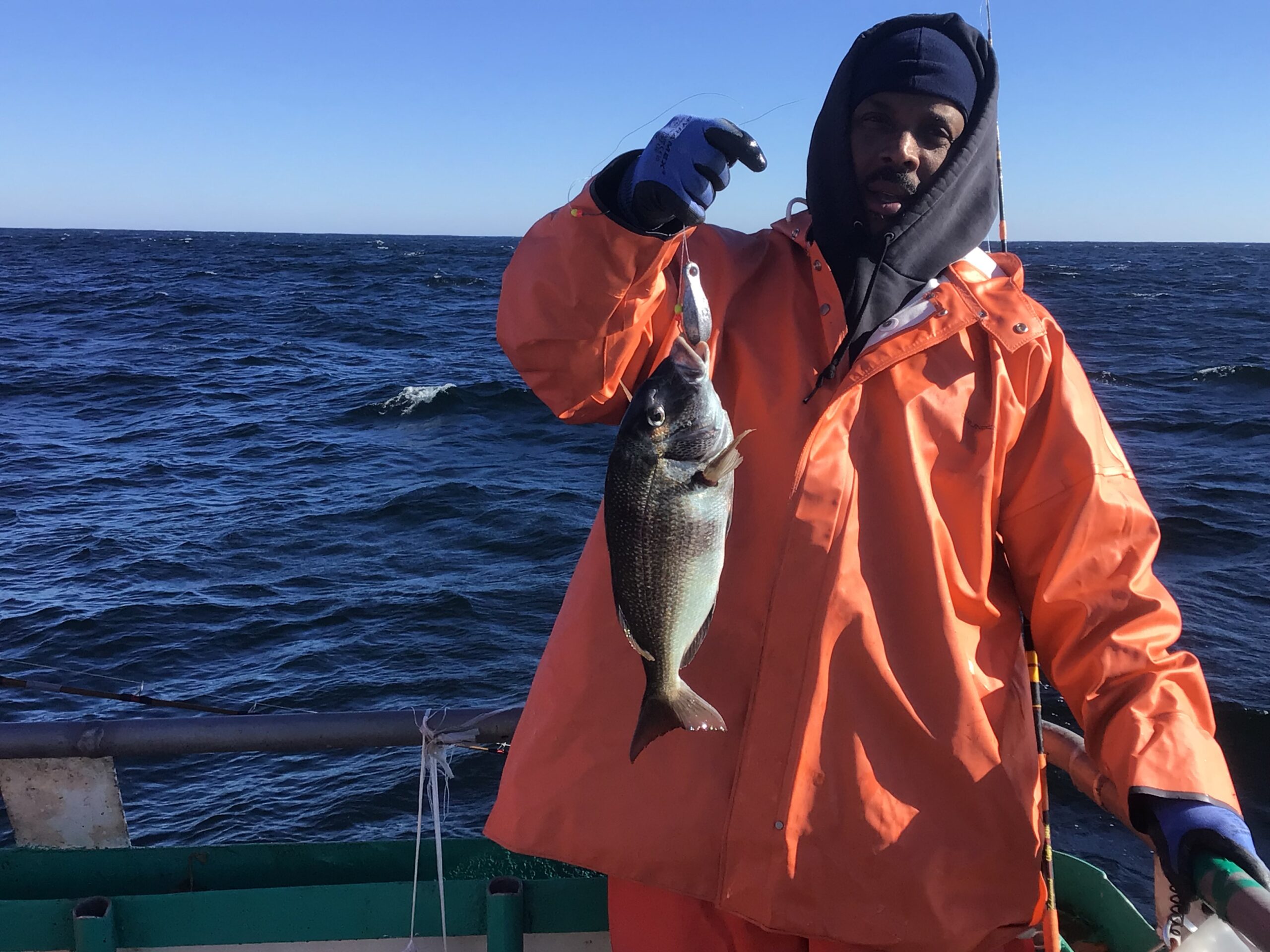 a man holding a fish in the water