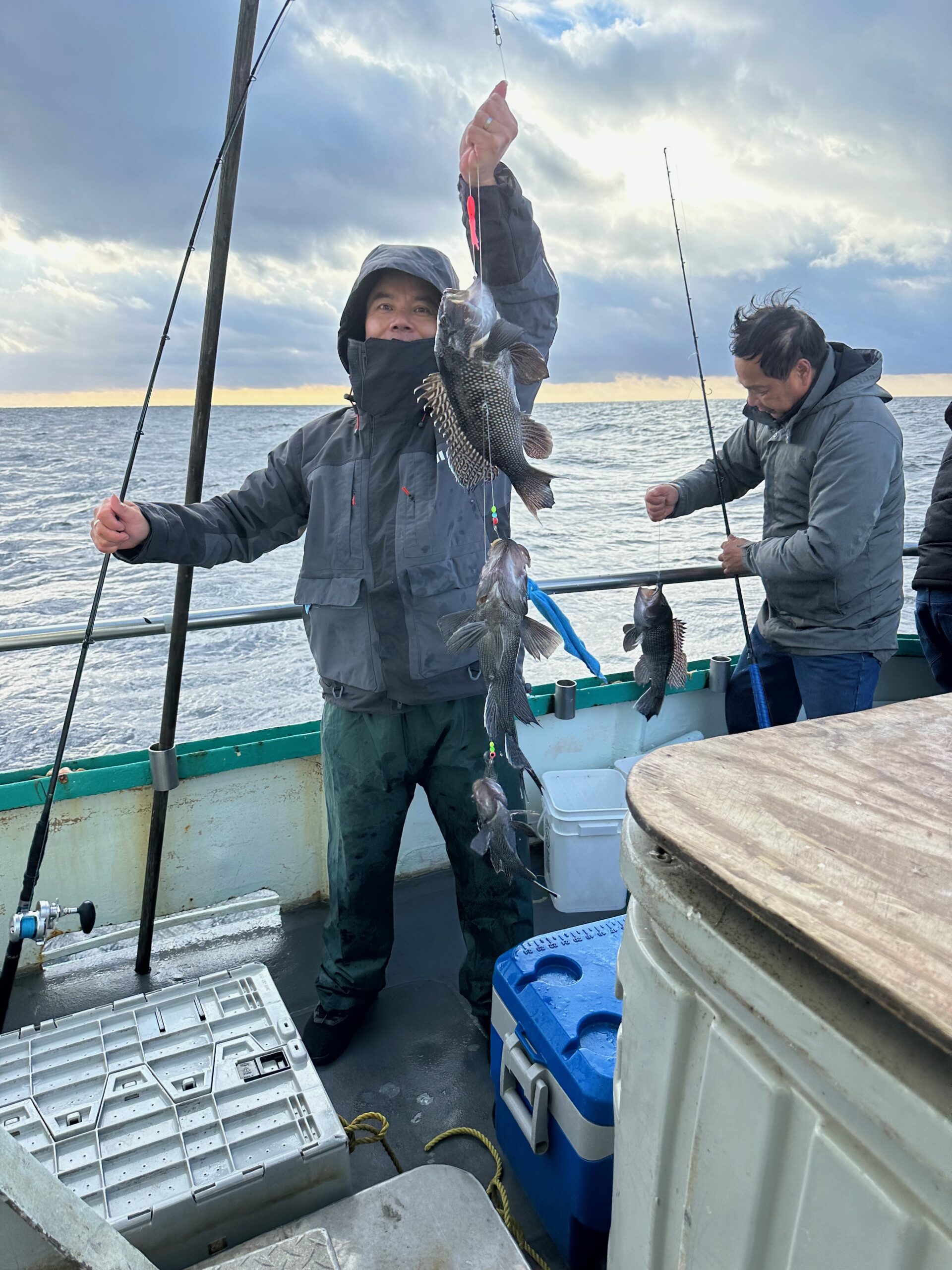 a person holding a fish on a boat