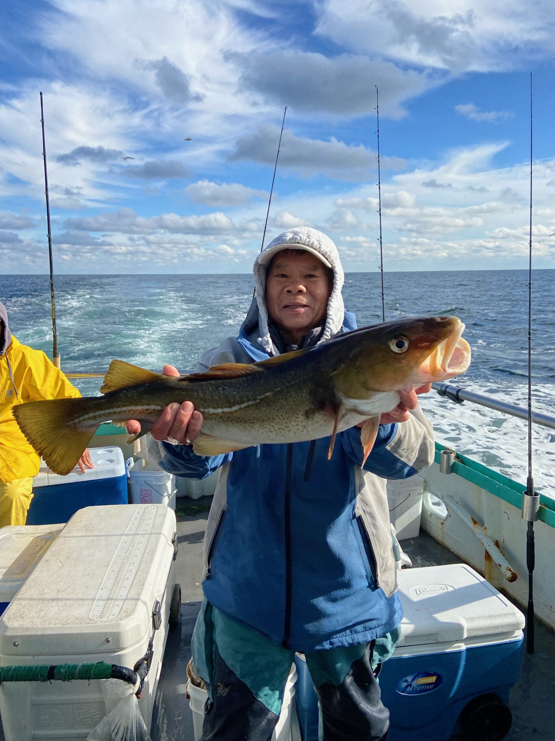 a person holding a fish on a boat