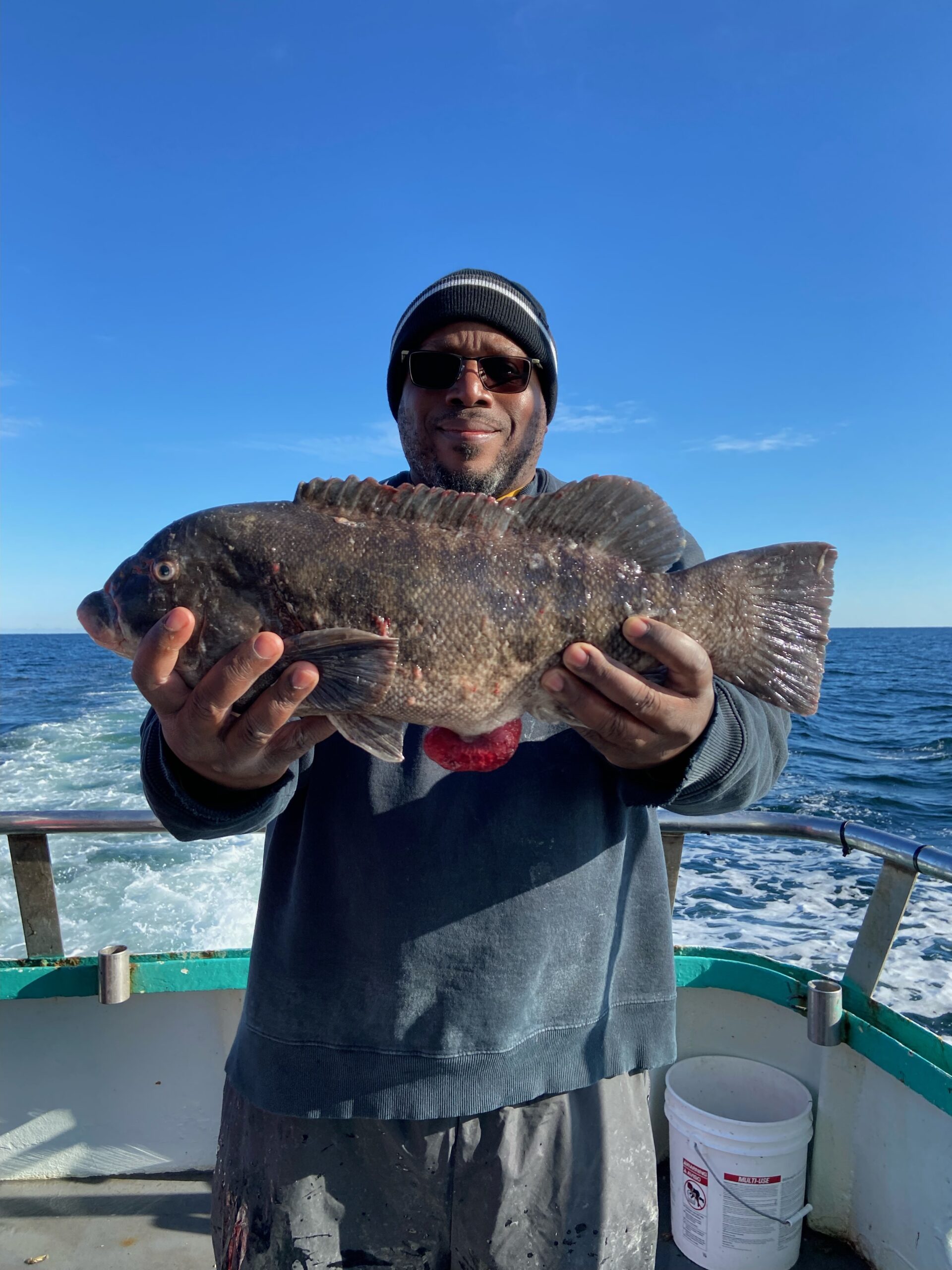 a man holding a fish in the water