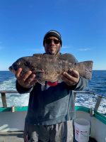 a man holding a fish in the water