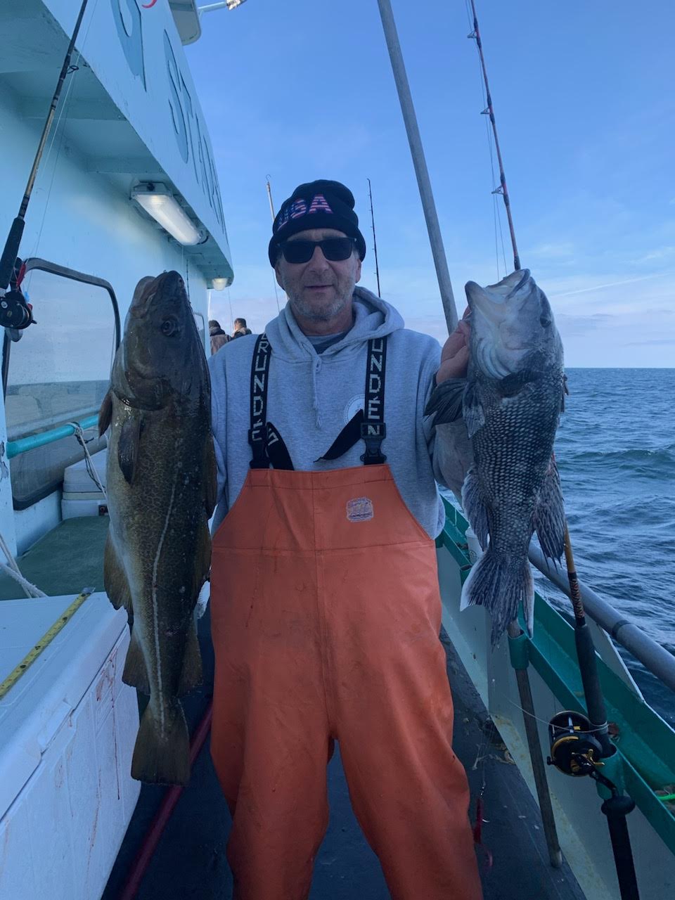a man holding a fish on a boat