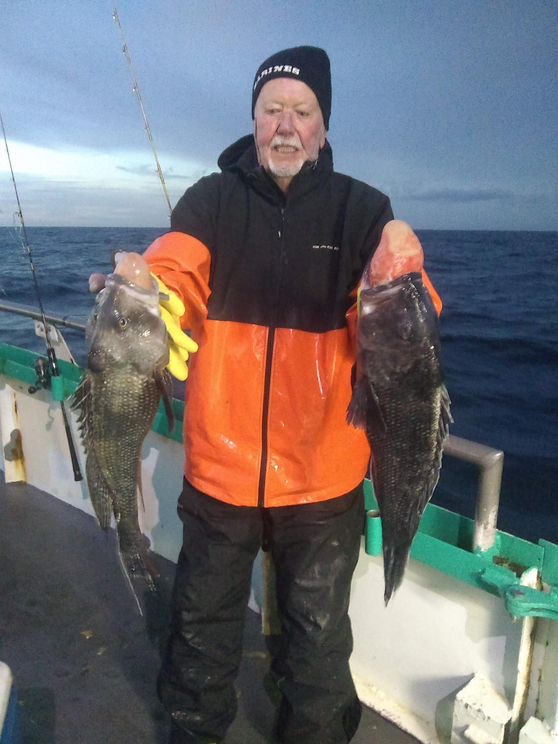 a man holding a fish in the water