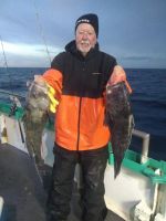 a man holding a fish in the water