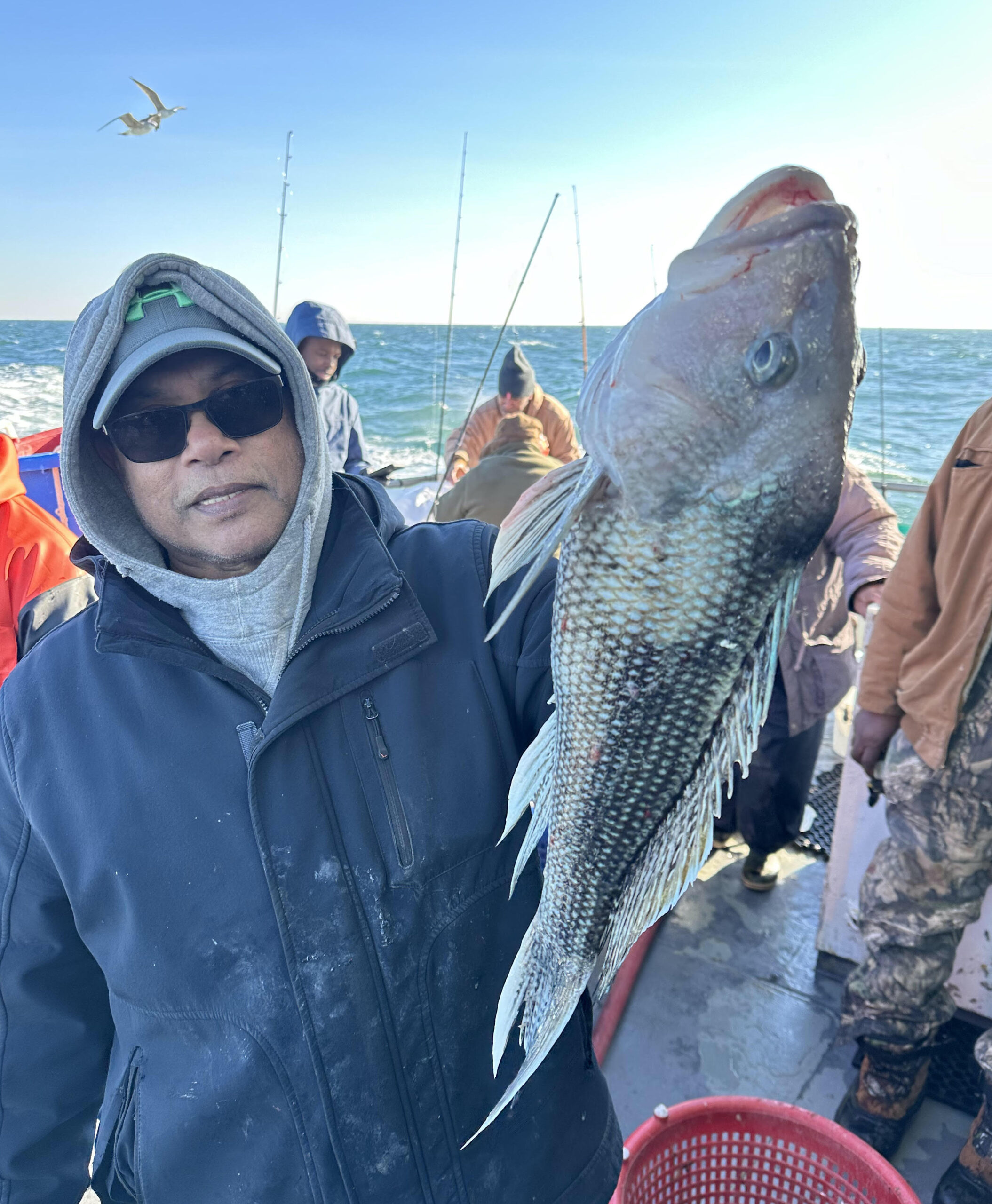 a man holding a fish in the water