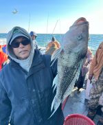 a man holding a fish in the water