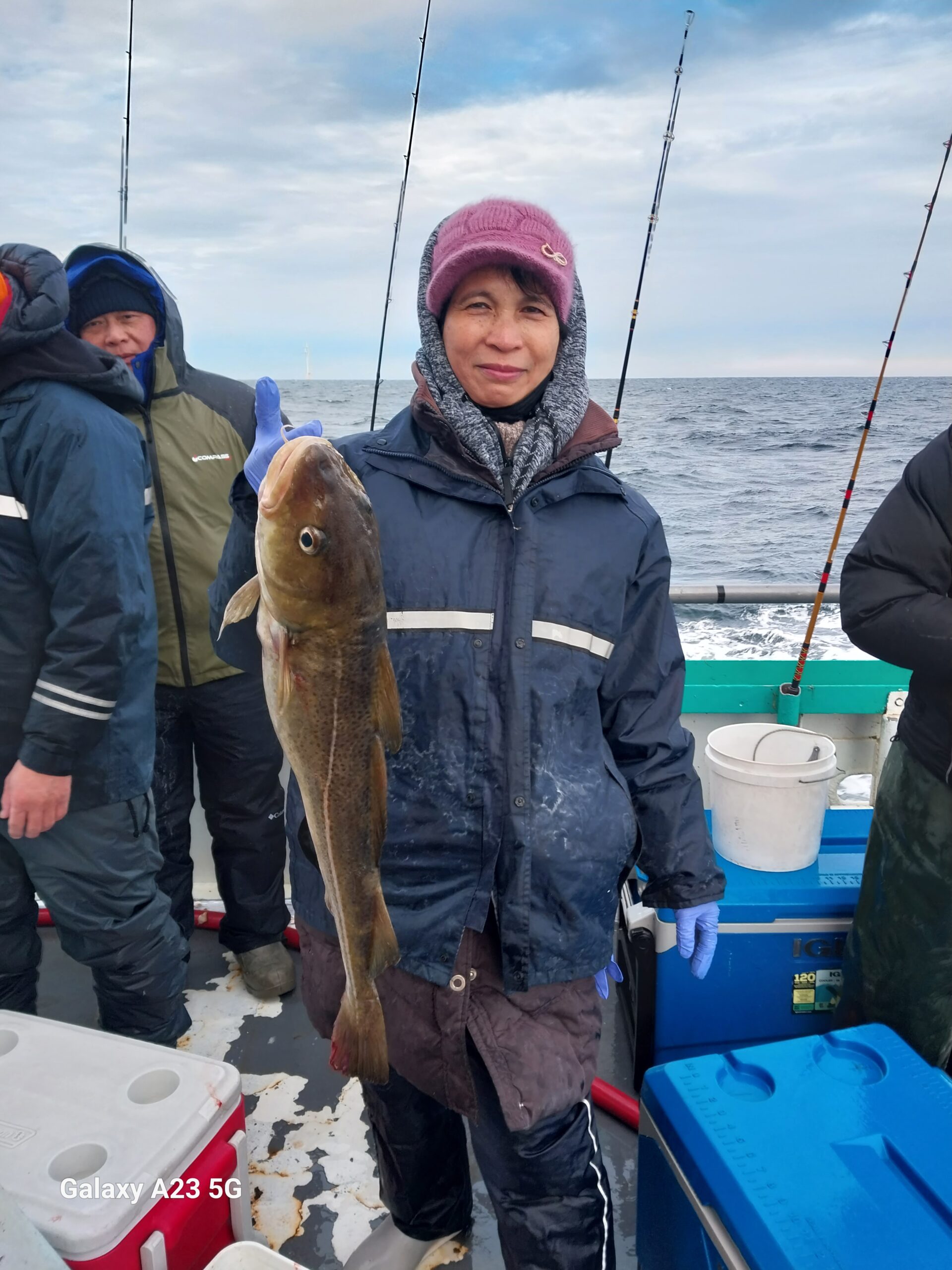 a person holding a fish on a boat