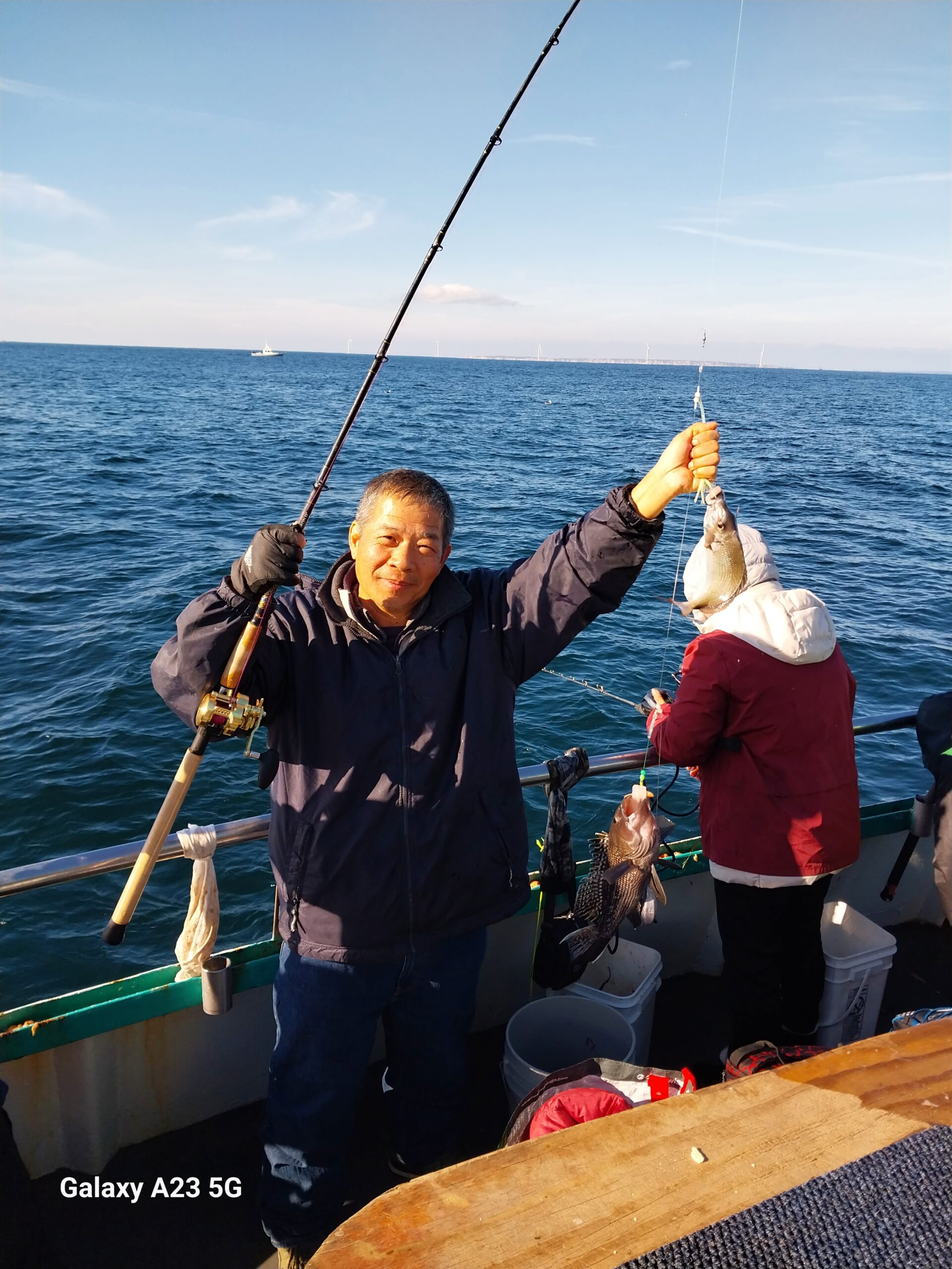 a man standing next to a body of water