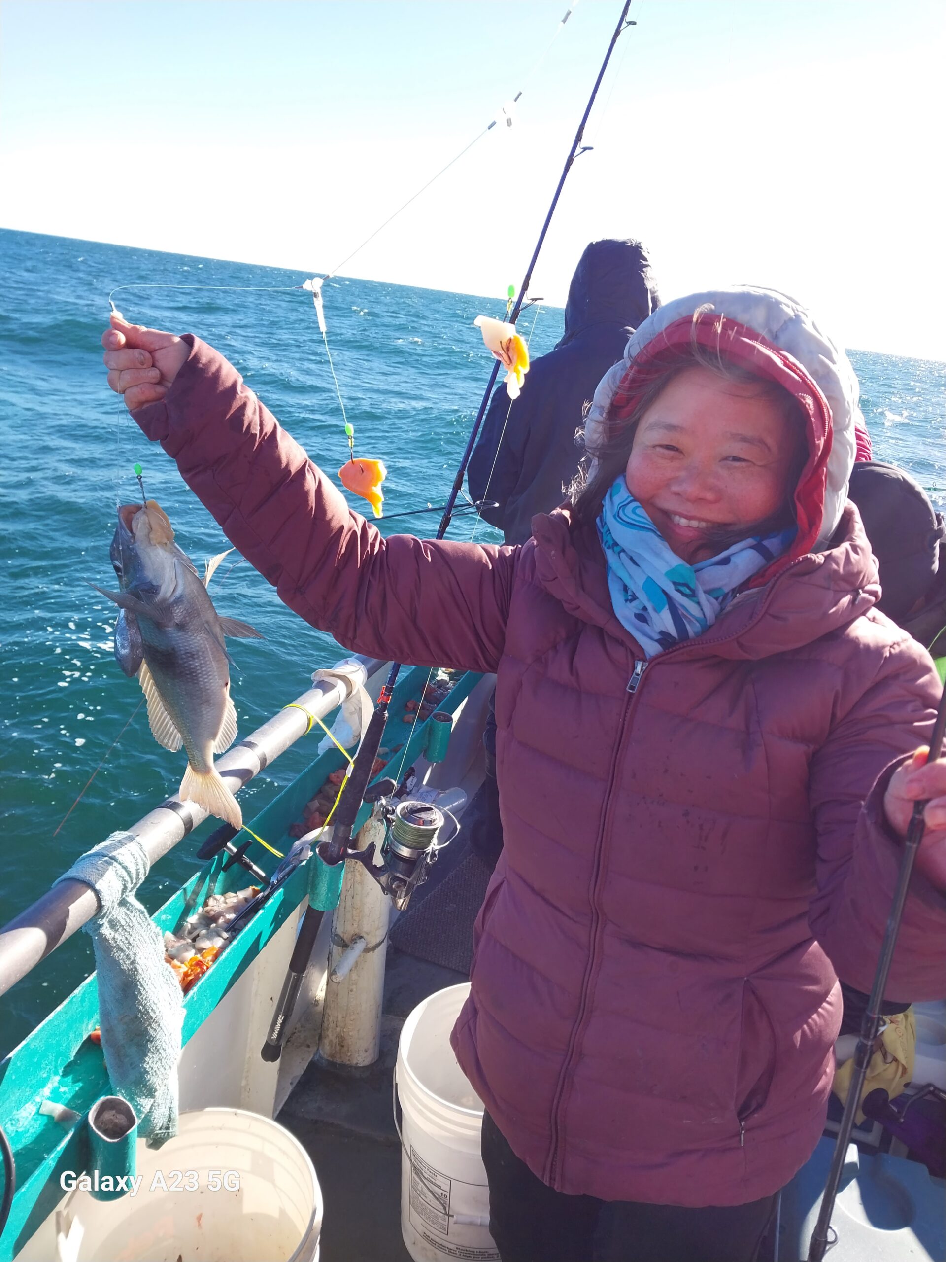 a person holding a kite in a boat on the water