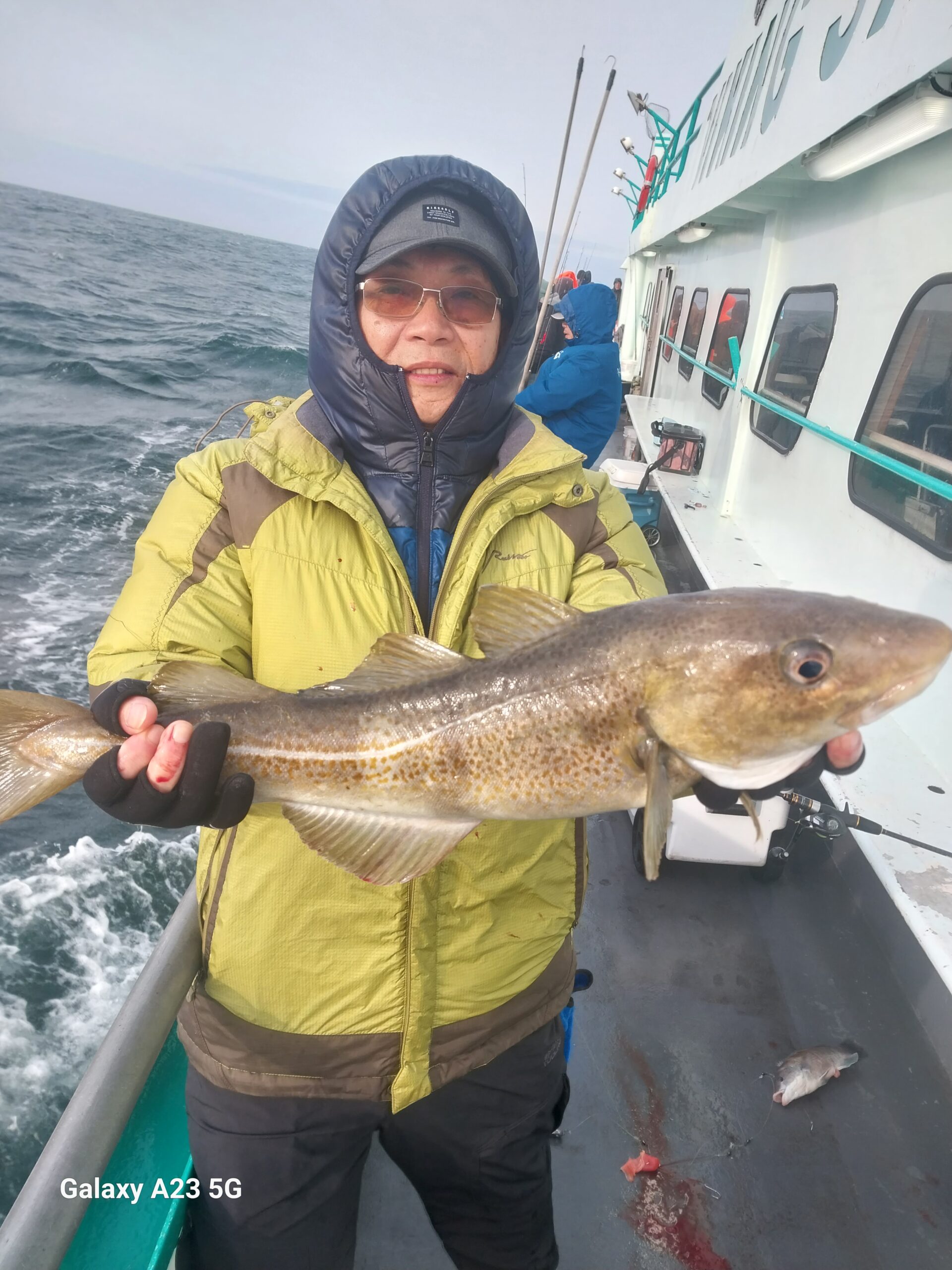 a person holding a fish in the water