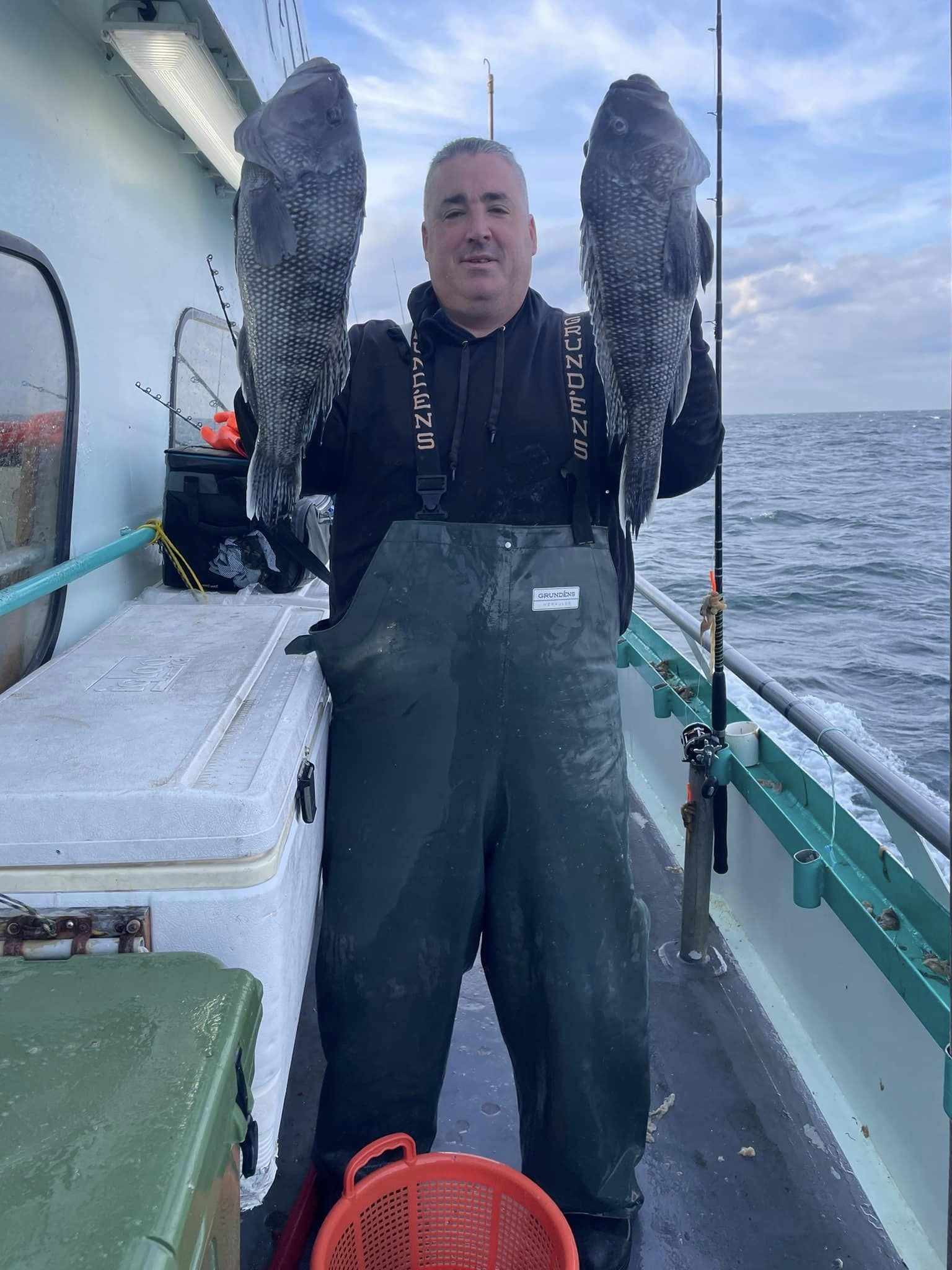 a person holding a fish in the water