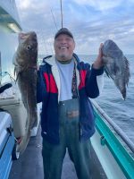 a person holding a fish on a boat