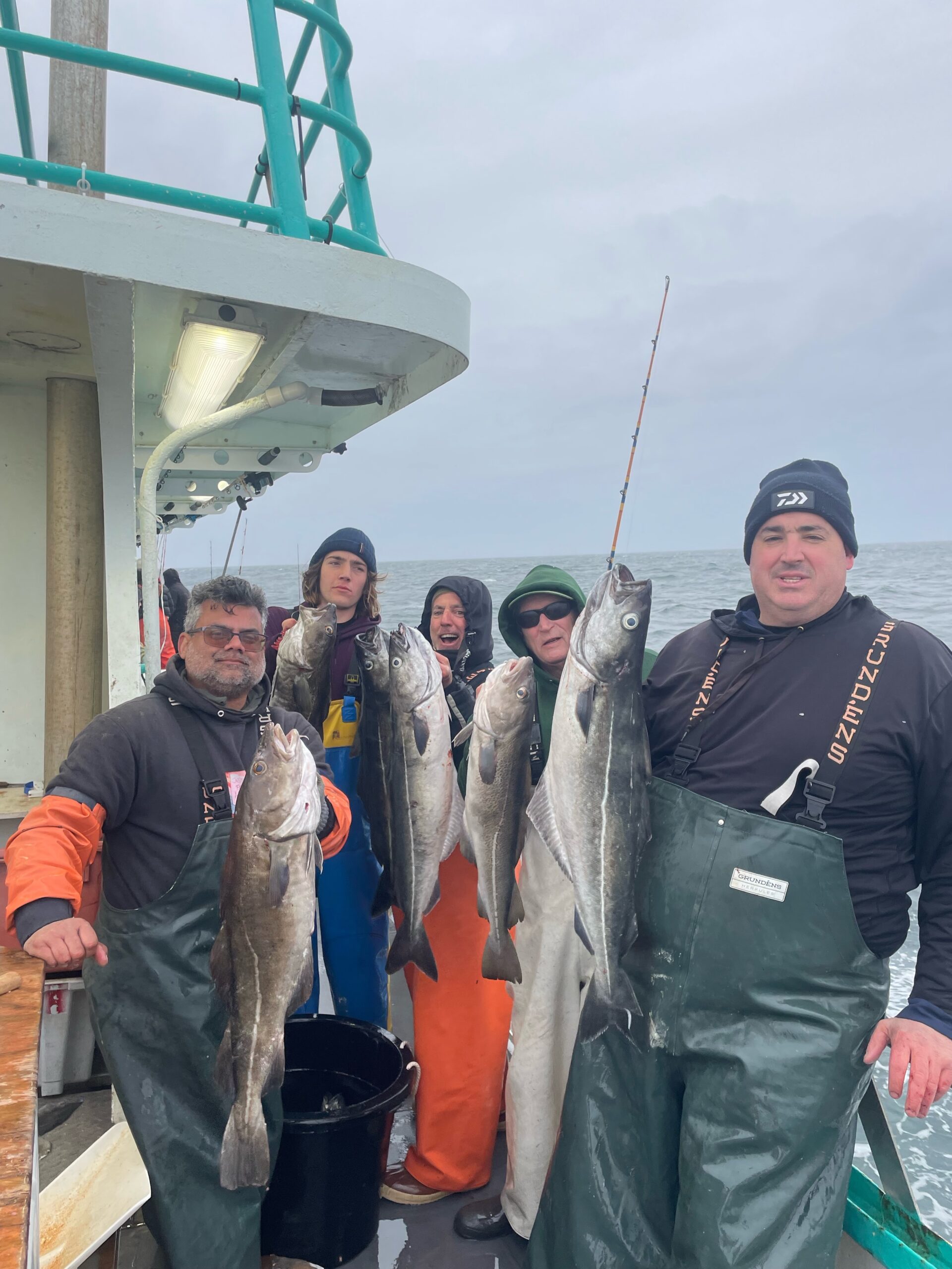 a group of people standing in front of a military man holding a fish