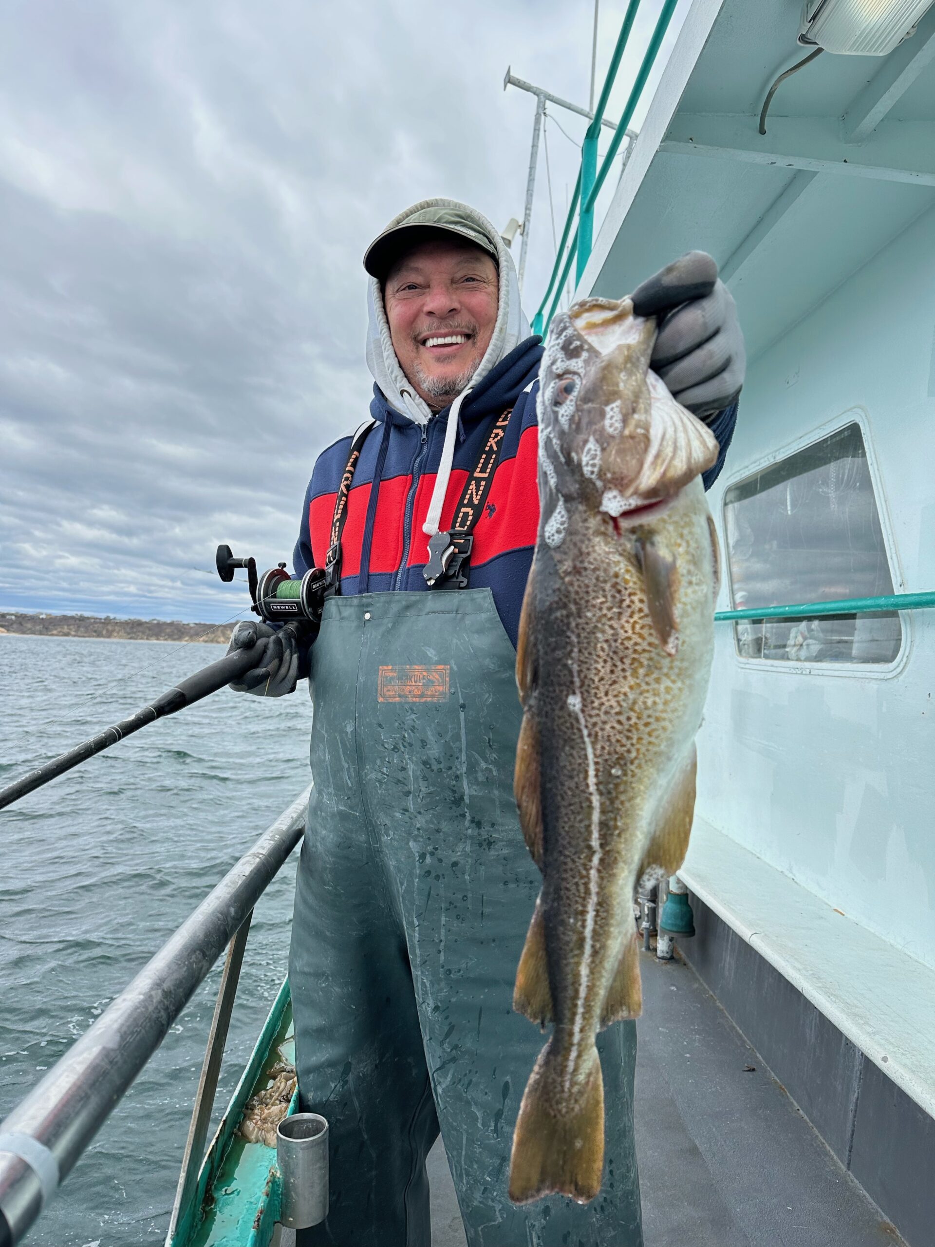 a person holding a fish on a boat in the water