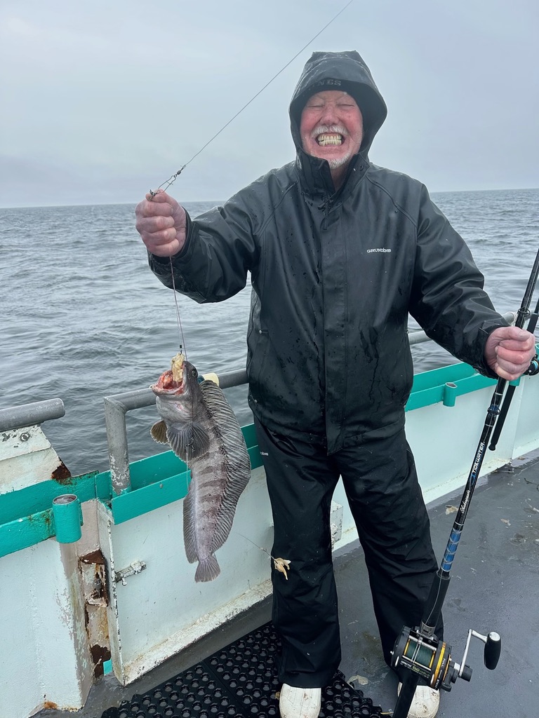 a person holding a kite in a boat on the water