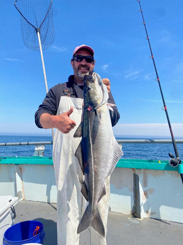 a man holding a fish in the water