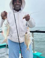 a person holding a fish in the water
