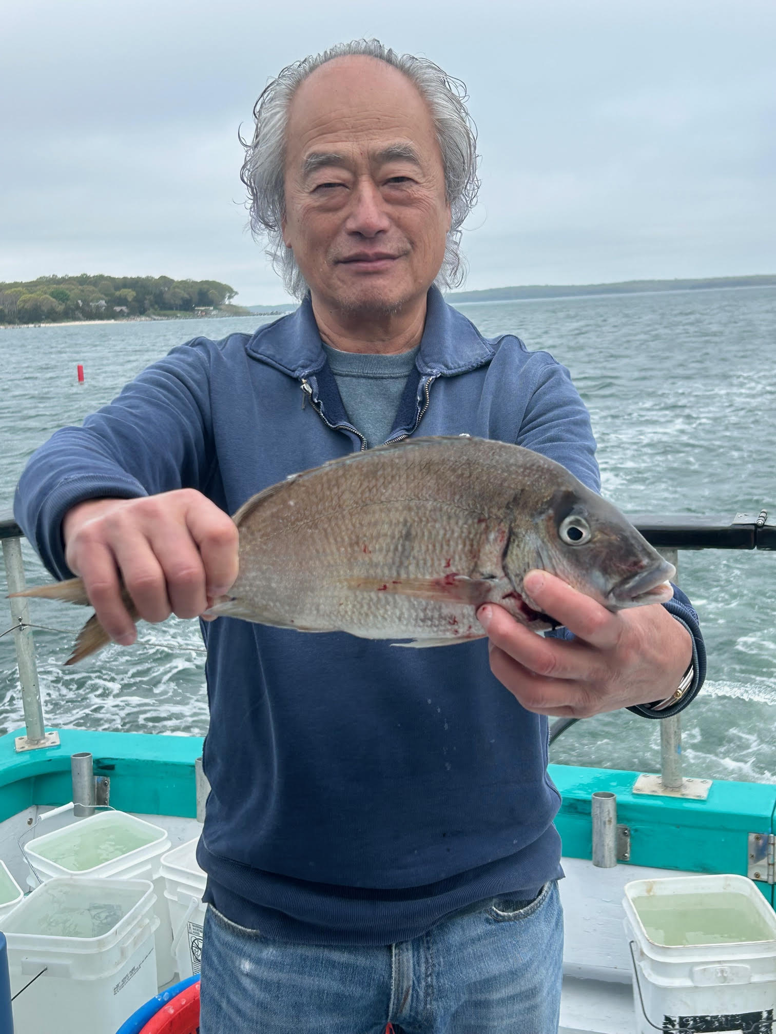 a man holding a fish in the water