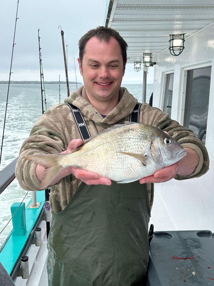 a man holding a fish