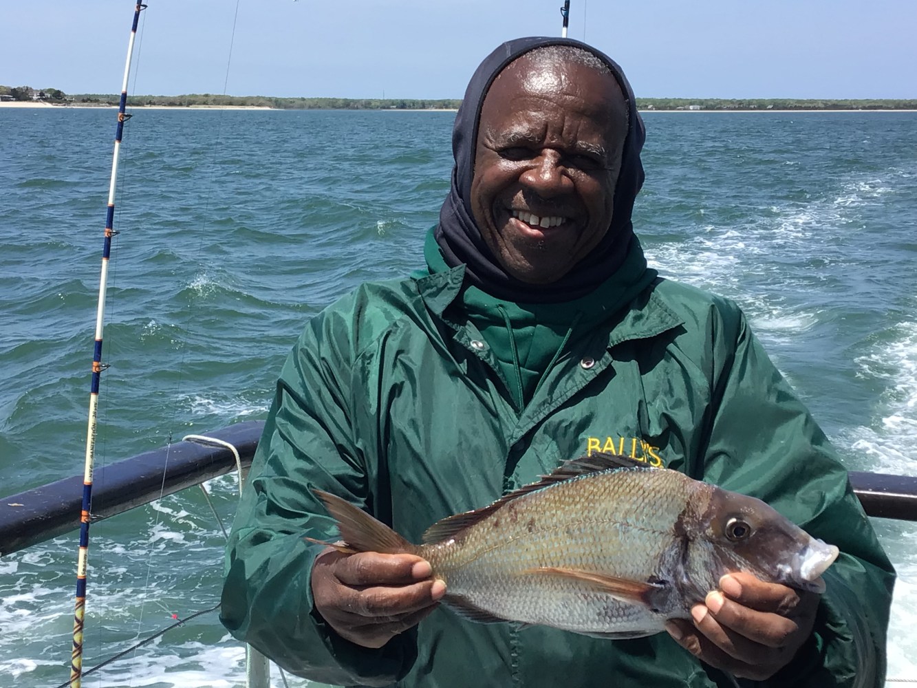 a man holding a fish in the water