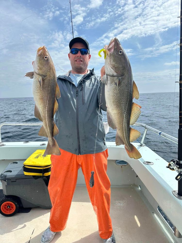 a person holding a fish on a boat