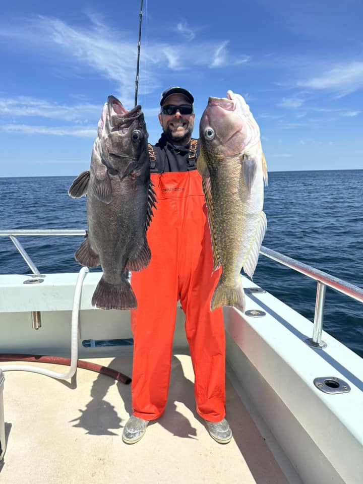 a man holding a fish in the water