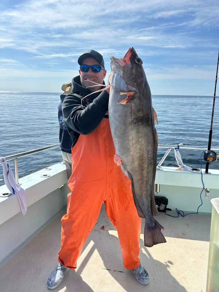 a person holding a fish in the water