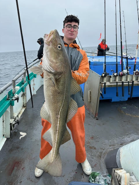 Jordi Tamargo holding a fish on a boat