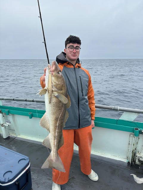 Jordi Tamargo holding a fish on a boat