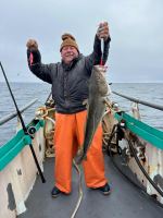 a person holding a fish on a boat