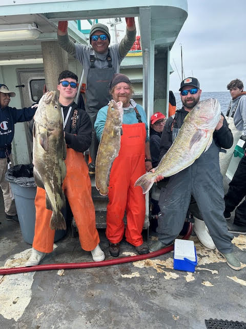 a group of people standing in front of a fish