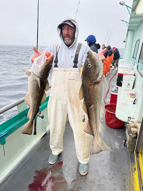 a person holding a fish in the water