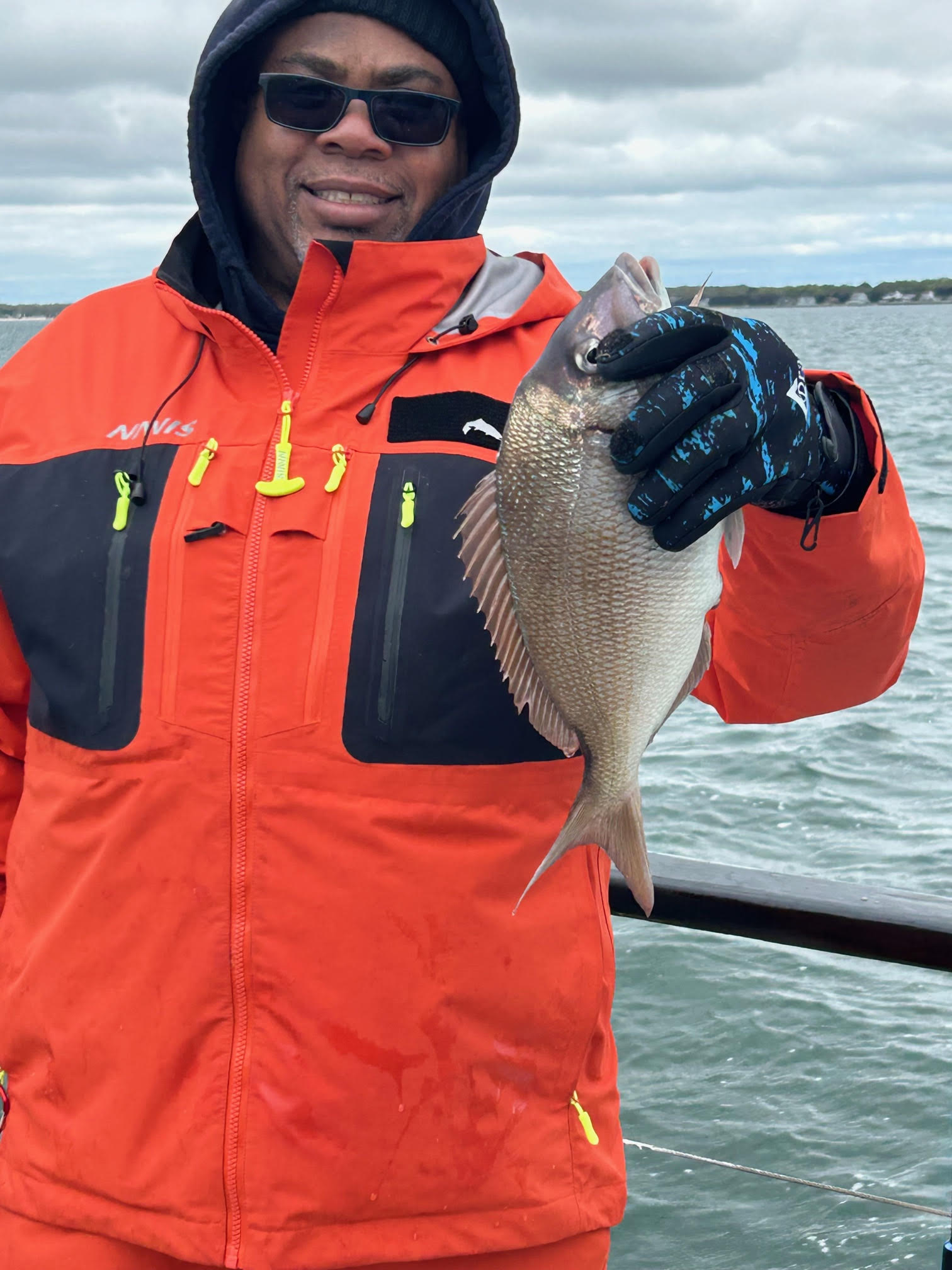 a person holding a fish in the water