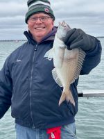 a person holding a fish in the water