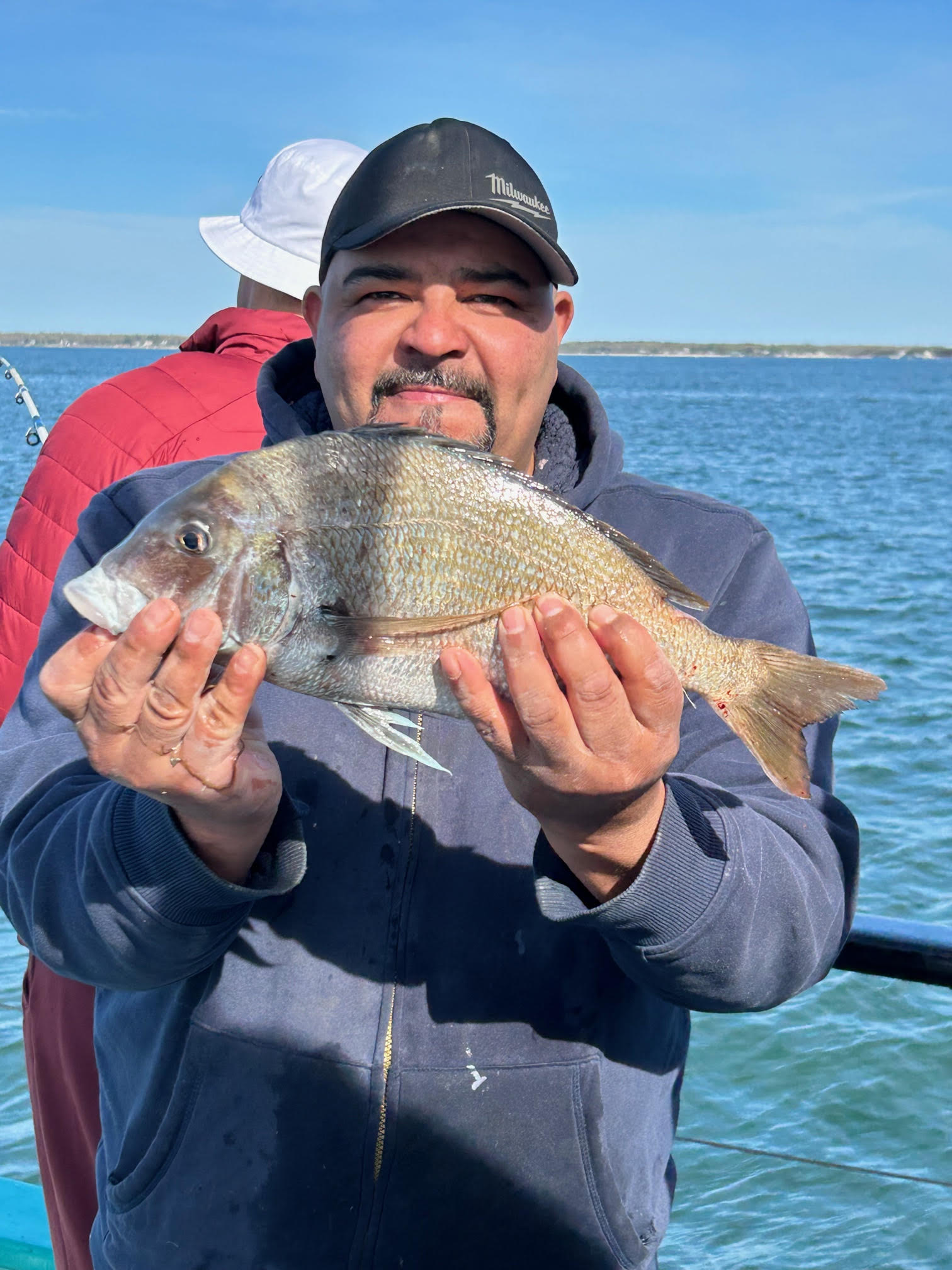 a person holding a fish in the water