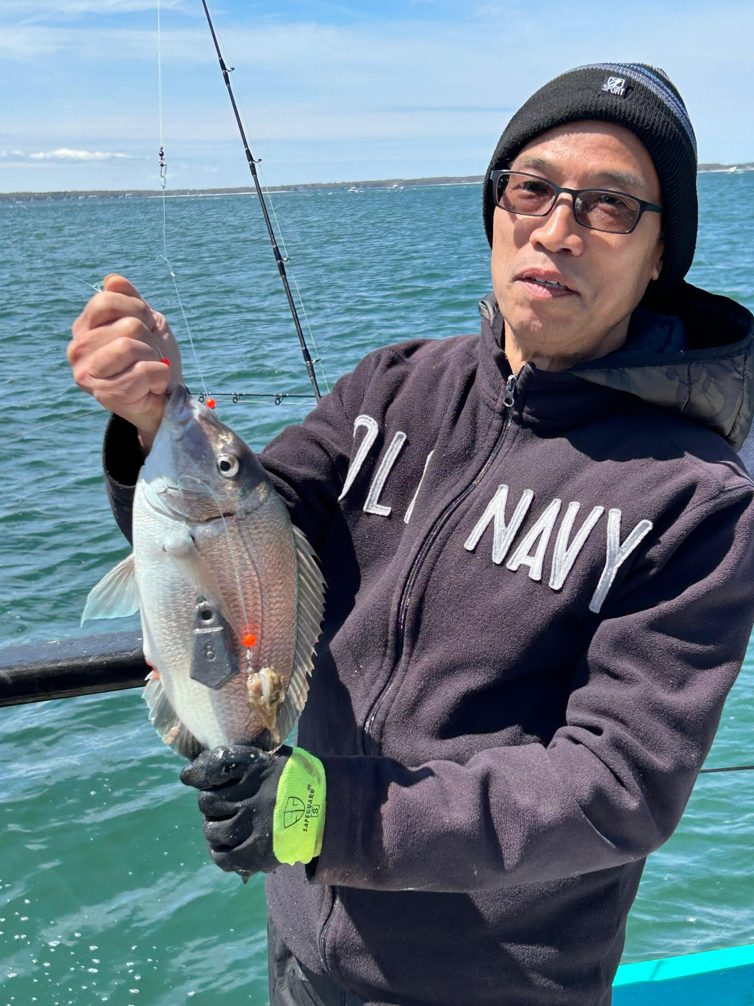 a man holding a fish in the water