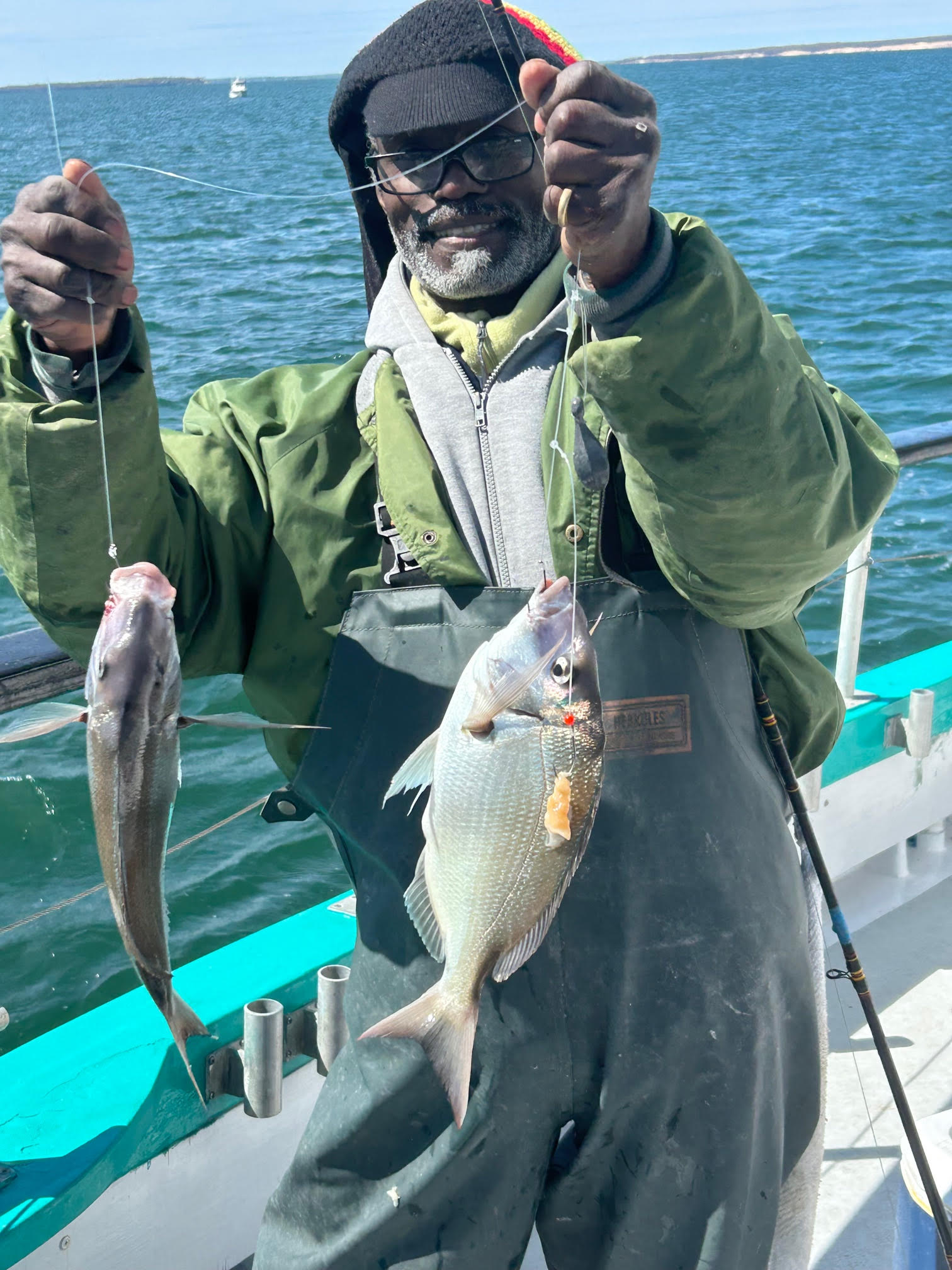 a man holding a fish in the water