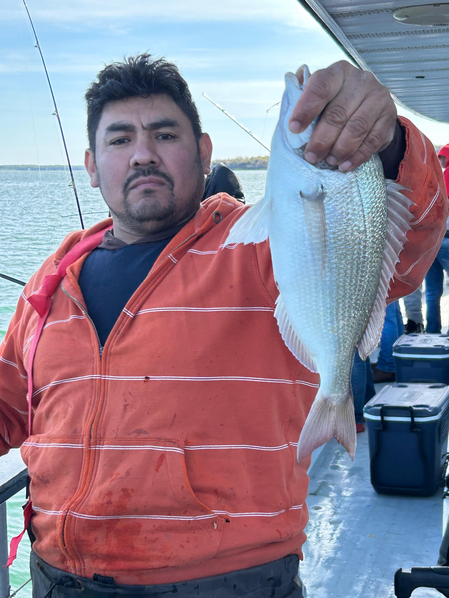 a man holding a fish in the water
