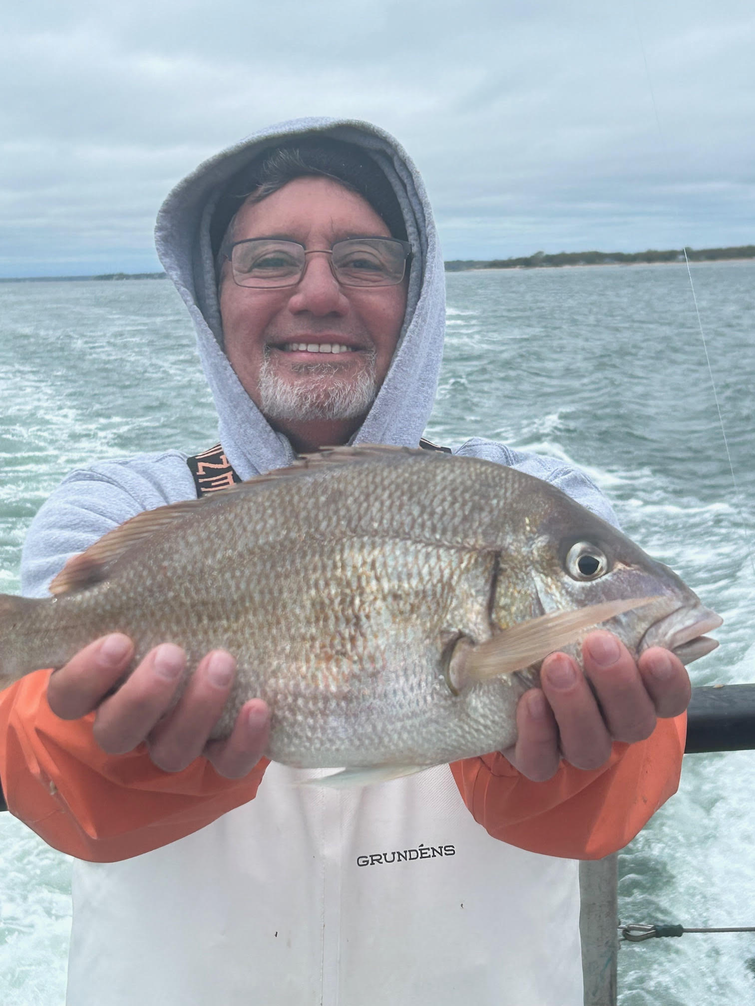a man holding a fish in the water