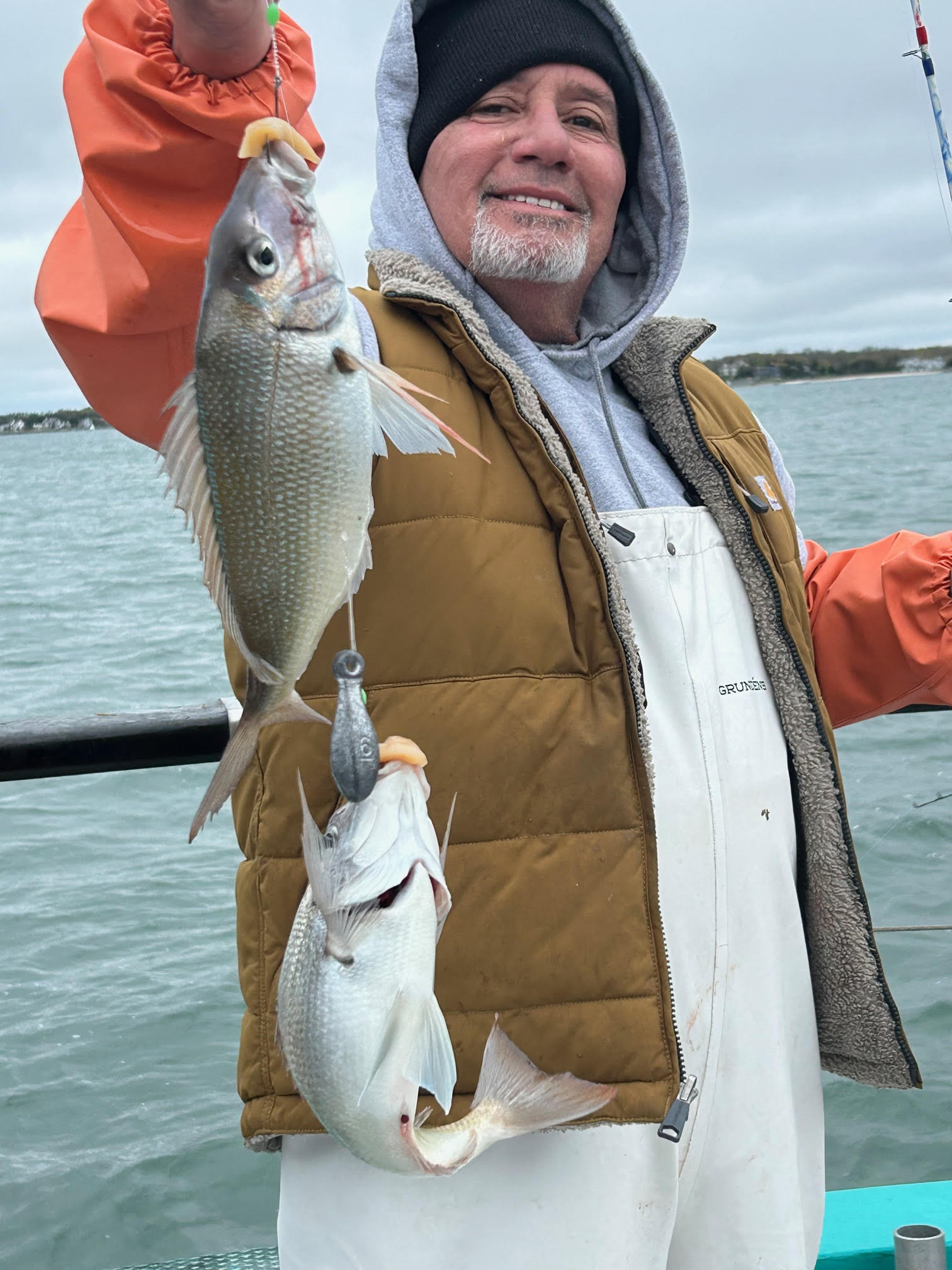 a person holding a fish in the water