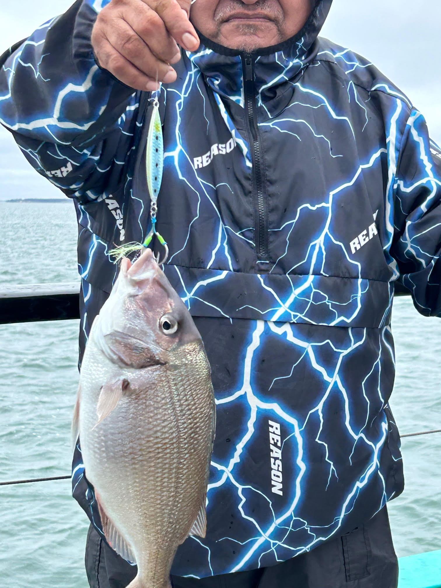 a man holding a fish in the water